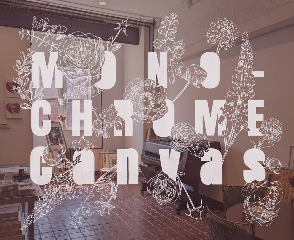 Artist print studio. Brick floors, tall ceilings, natural light, large format printer. Monochrome Canvas floral logo overlay.