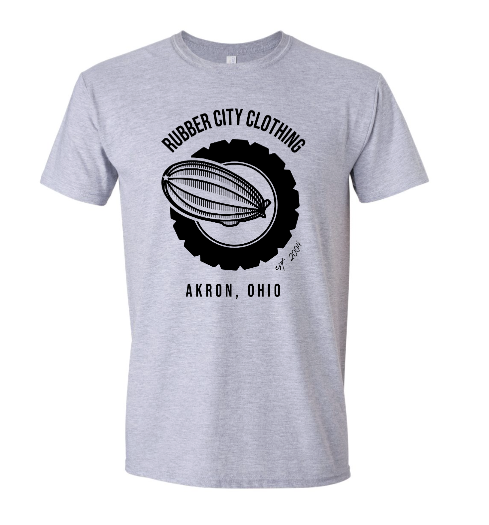 Grey t-shirt featuring Rubber City Clothing Logo of Blimp flying through tire designed by Joëlle of Monochrome Canvas in rebrand