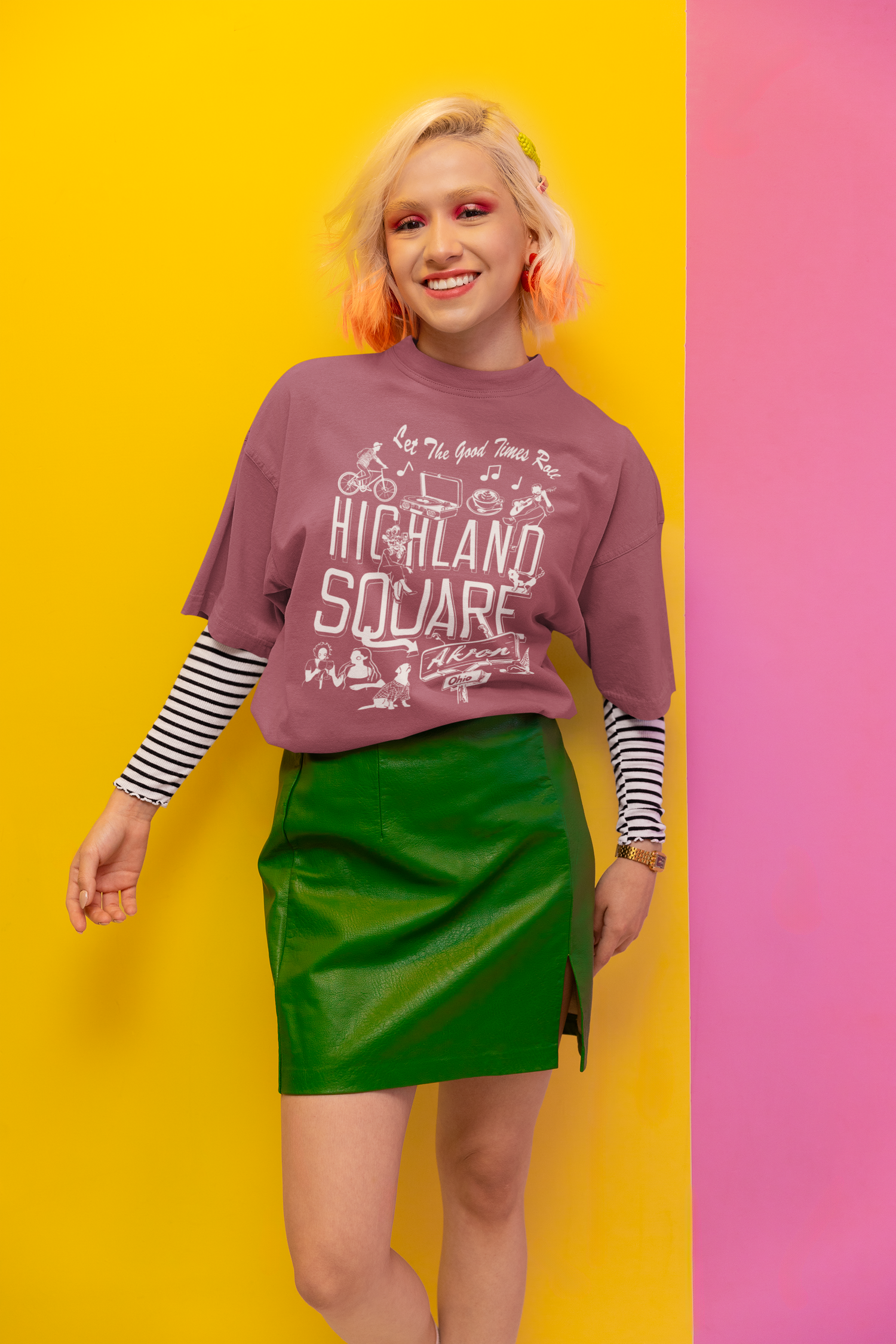 Eclectic Woman wearing pink Highland Square Akron Ohio T-shirt designed by Monochrome Canvas and printed locally by Micah Kraus of Work Studio LTD. Each item is thrifted locally and unique to the collection. Visit Rubber City Clothing to products available