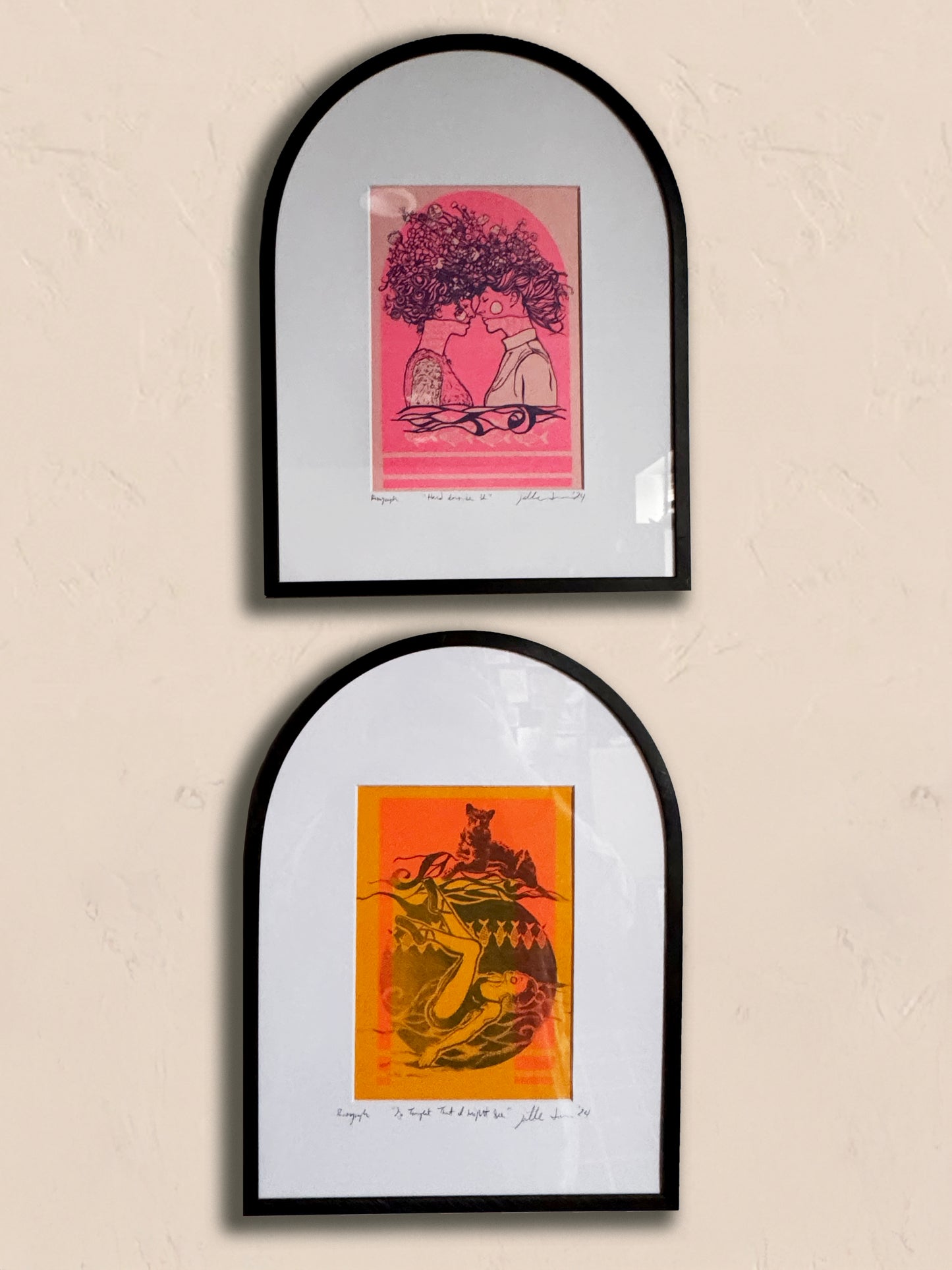 Two framed risograph prints in metal black arched frames on a beige wall. Artist: Joëlle Diane