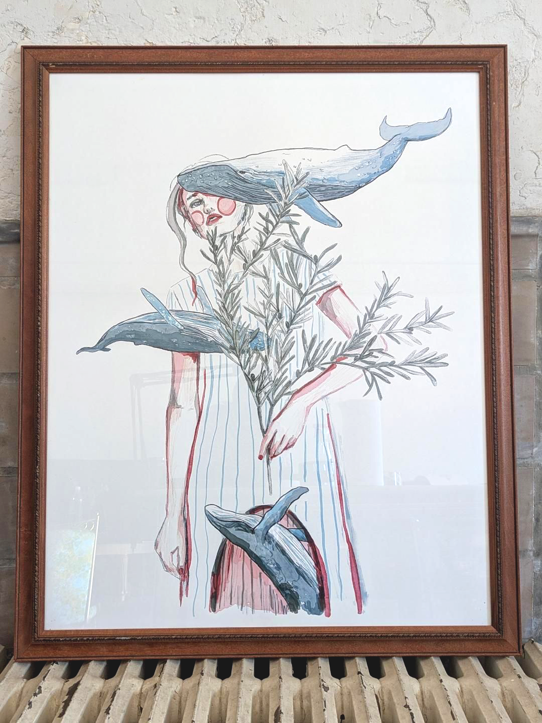 Framed artwork of a woman with blue whales and olive branch with white background